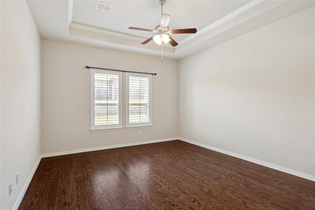 2104 Ladera Way, Unit 2104 Mansfield, TX 76063 - Photo 16 of 27 an empty room with wooden floor and windows