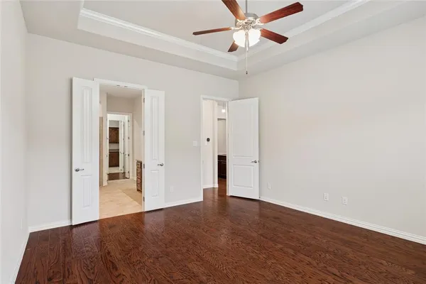 a view of a livingroom with a ceiling fan and wooden floor