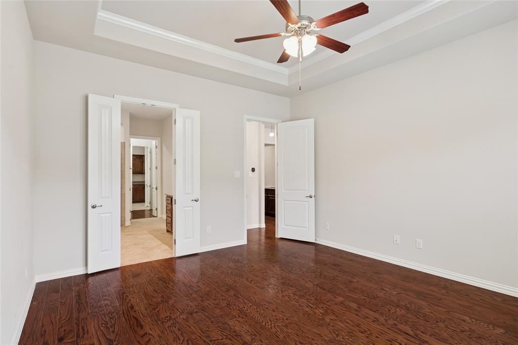 2104 Ladera Way, Unit 2104 Mansfield, TX 76063 - Photo 17 of 27 a view of a livingroom with a ceiling fan and wooden floor