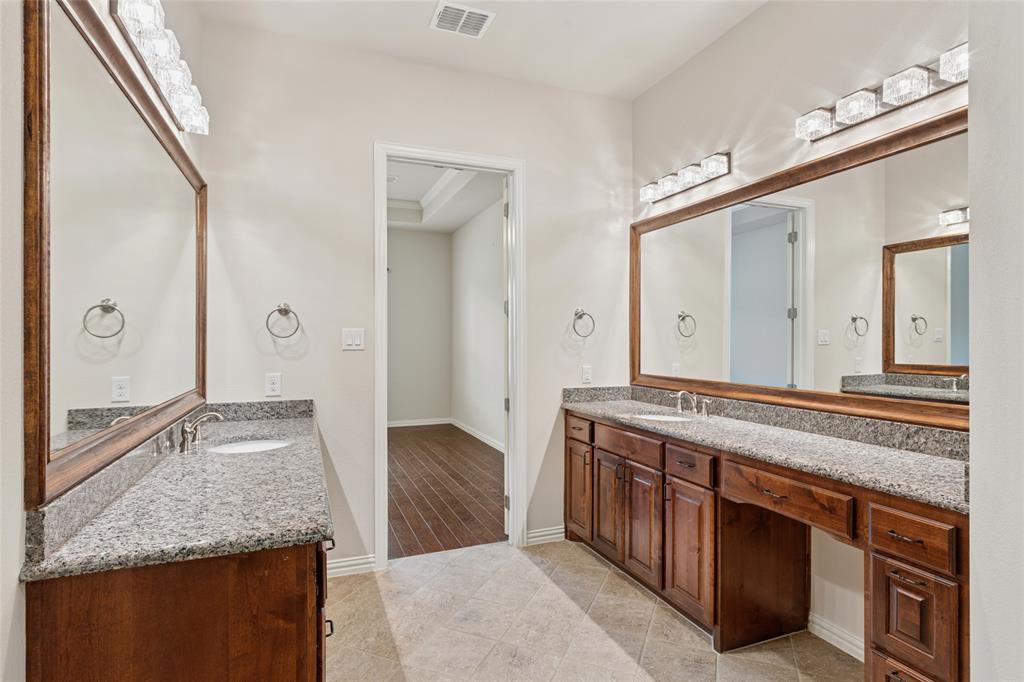 2104 Ladera Way, Unit 2104 Mansfield, TX 76063 - Photo 20 of 27 a spacious bathroom with a granite countertop double vanity sink and a mirror