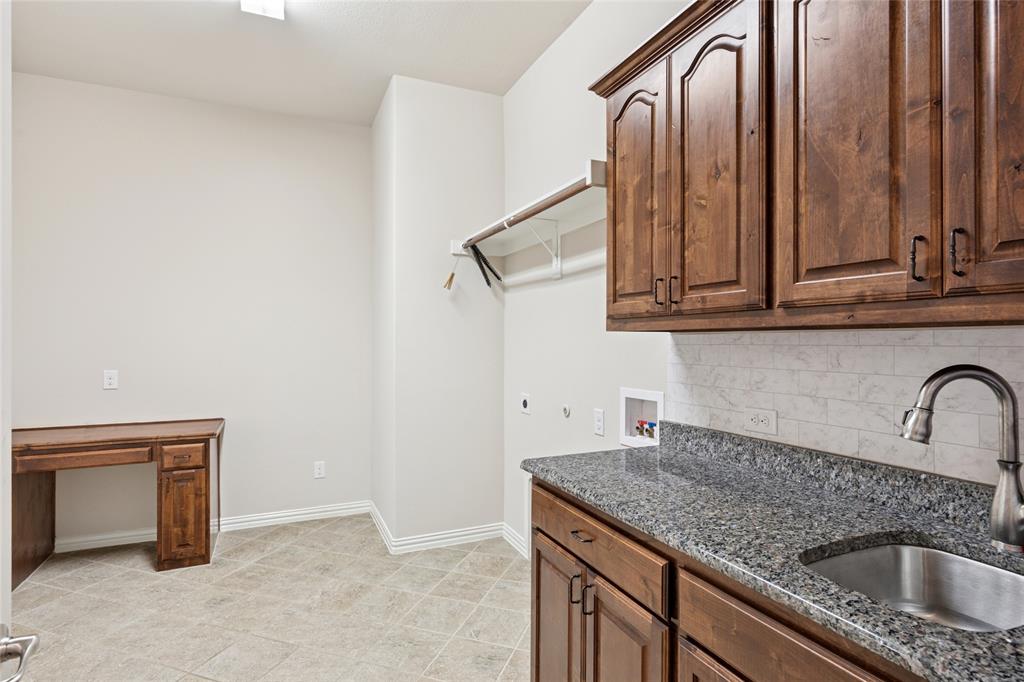 2104 Ladera Way, Unit 2104 Mansfield, TX 76063 - Photo 22 of 27 a kitchen with a sink and cabinets
