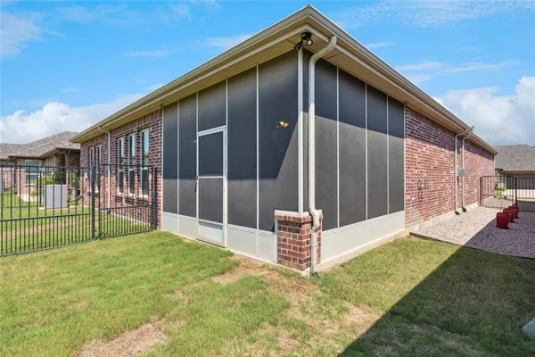 a backyard of a house with table and chairs