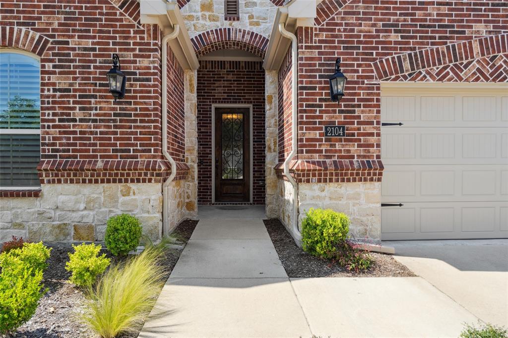 2104 Ladera Way, Unit 2104 Mansfield, TX 76063 - Photo 3 of 27 a front view of a house with a yard