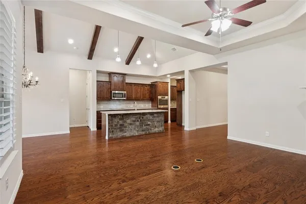 a view of a kitchen with a sink and refrigerator