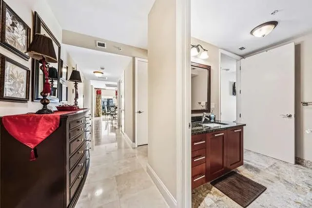 a view of a hallway and a livingroom with furniture