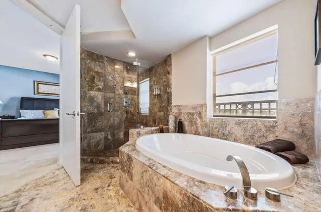 a spacious bathroom with a bathtub and shower