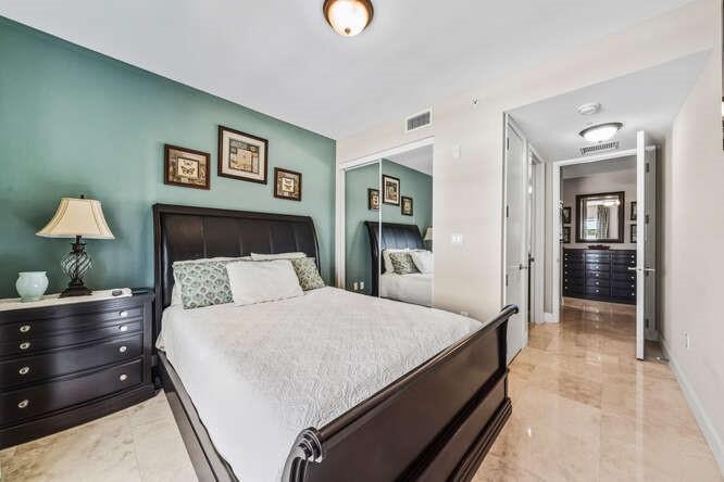 2401 North Ocean Boulevard, Unit 500 Fort Lauderdale, FL 33305 - Photo 19 of 38 a bedroom with a bed and a table