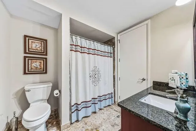 a white toilet sitting next to a bathroom sink
