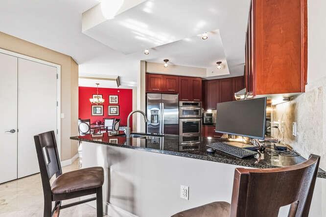 2401 North Ocean Boulevard, Unit 500 Fort Lauderdale, FL 33305 - Photo 2 of 38 a room with stainless steel appliances kitchen island granite countertop a sink and cabinets