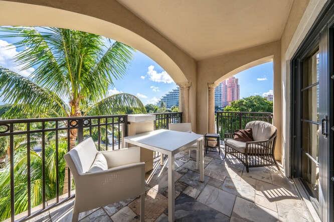 2401 North Ocean Boulevard, Unit 500 Fort Lauderdale, FL 33305 - Photo 22 of 38 a view of a patio with couches chairs and wooden floor