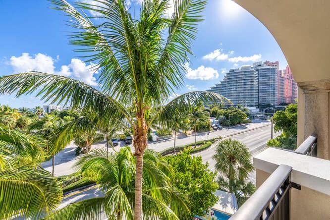 2401 North Ocean Boulevard, Unit 500 Fort Lauderdale, FL 33305 - Photo 24 of 38 a view of a backyard with plants and palm trees