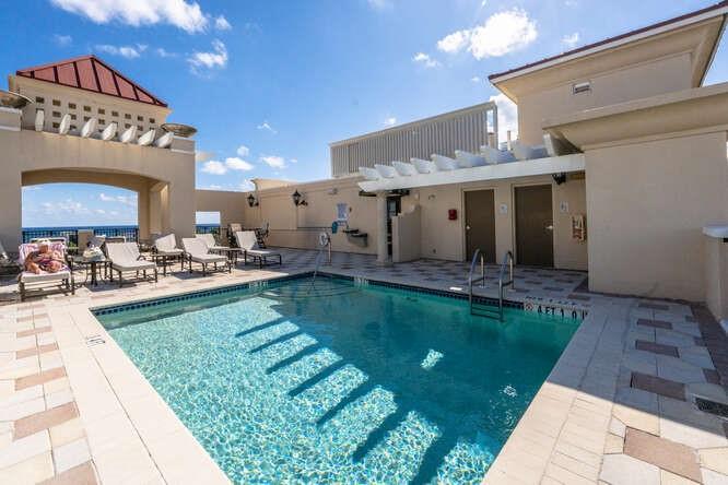 2401 North Ocean Boulevard, Unit 500 Fort Lauderdale, FL 33305 - Photo 29 of 38 a view of a house with a swimming pool and a yard