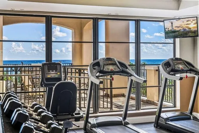 a view of a patio with couches table and chairs and wooden floor