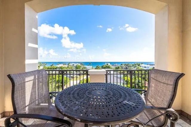 a living room with patio furniture and a floor to ceiling window