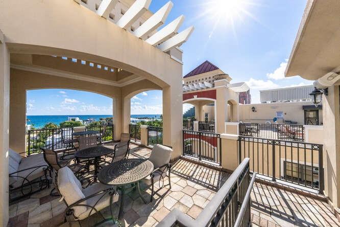 2401 North Ocean Boulevard, Unit 500 Fort Lauderdale, FL 33305 - Photo 33 of 38 a view of a patio with couches table and chairs and wooden floor