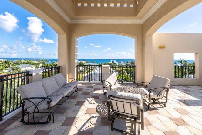2401 North Ocean Boulevard, Unit 500 Fort Lauderdale, FL 33305 - Photo 34 of 38 a living room with patio furniture and a floor to ceiling window