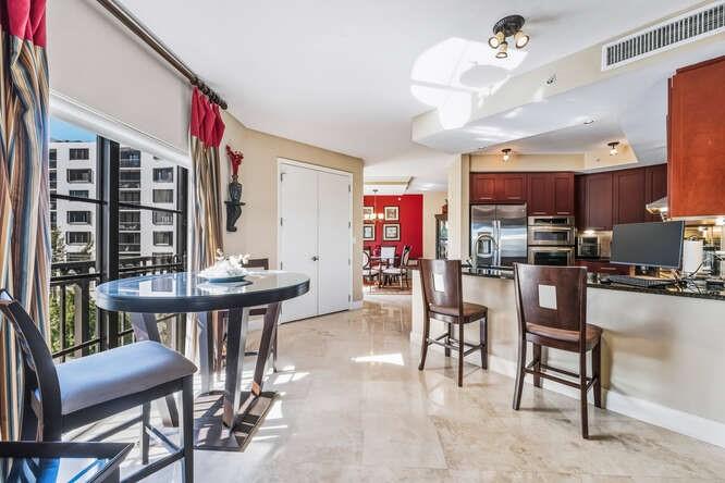 2401 North Ocean Boulevard, Unit 500 Fort Lauderdale, FL 33305 - Photo 4 of 38 a view of a dining room with furniture and chandelier
