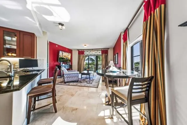 a dining room with furniture and a large window