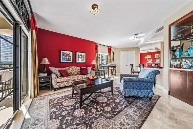 a living room with furniture rug and a window