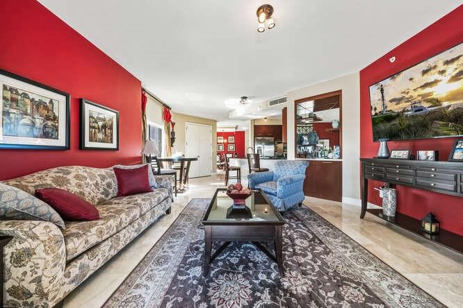 2401 North Ocean Boulevard, Unit 500 Fort Lauderdale, FL 33305 - Photo 8 of 38 a living room with furniture a rug and a floor to ceiling window