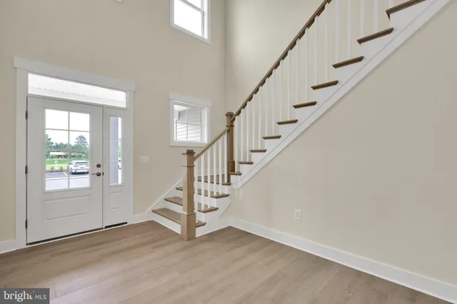 a view of entryway with wooden floor and stairs