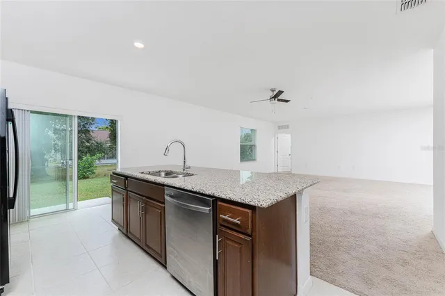 an empty room with a ceiling fan and closet area