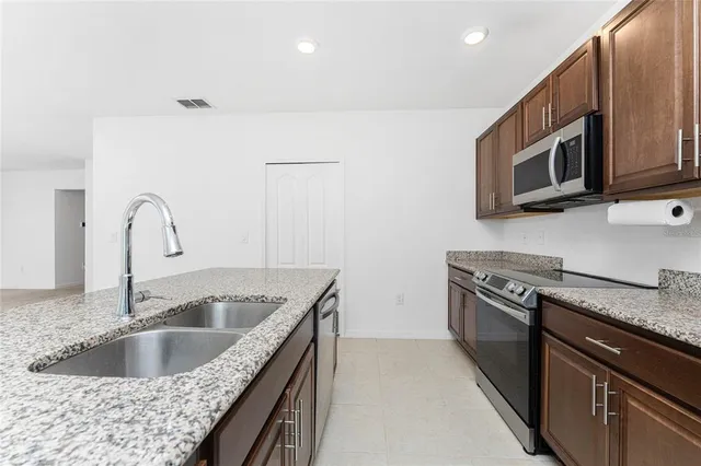 an empty room with a ceiling fan and a window