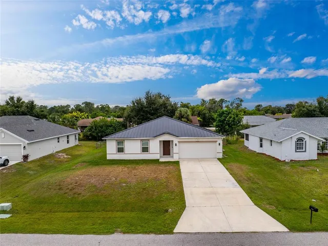 an aerial view of residential houses with outdoor space and swimming pool