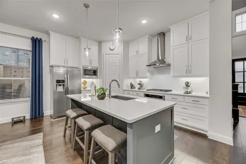 a kitchen with a sink stove and refrigerator