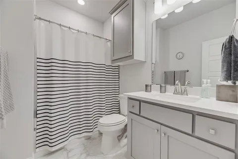 a bathroom with a sink a toilet and mirror