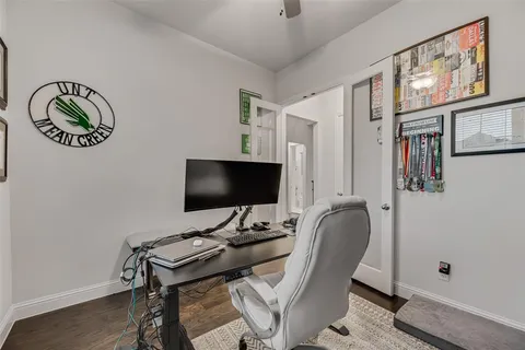 a view of a workspace with furniture and a flat screen tv