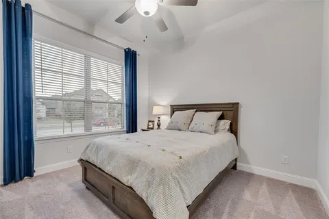 a bedroom with a bed and a large window