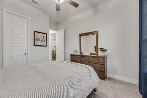 a bedroom with a bed and a mirror