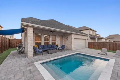 a view of a house with backyard sitting area and garden
