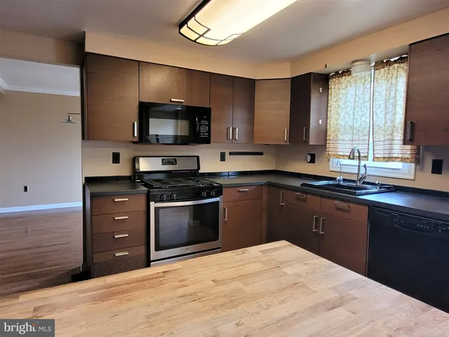 a kitchen with a sink stove and microwave