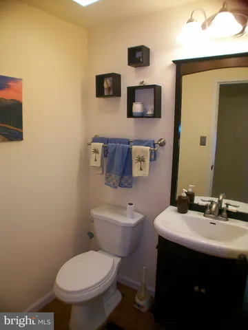 a bathroom with a sink a toilet and mirror