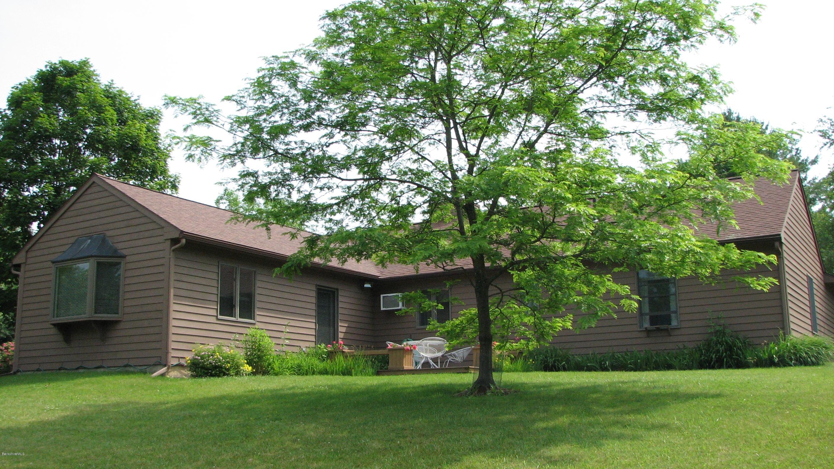 16 Hill Road Stockbridge, MA 01266 - Photo 1 of 20 a view of a backyard with plants and large trees