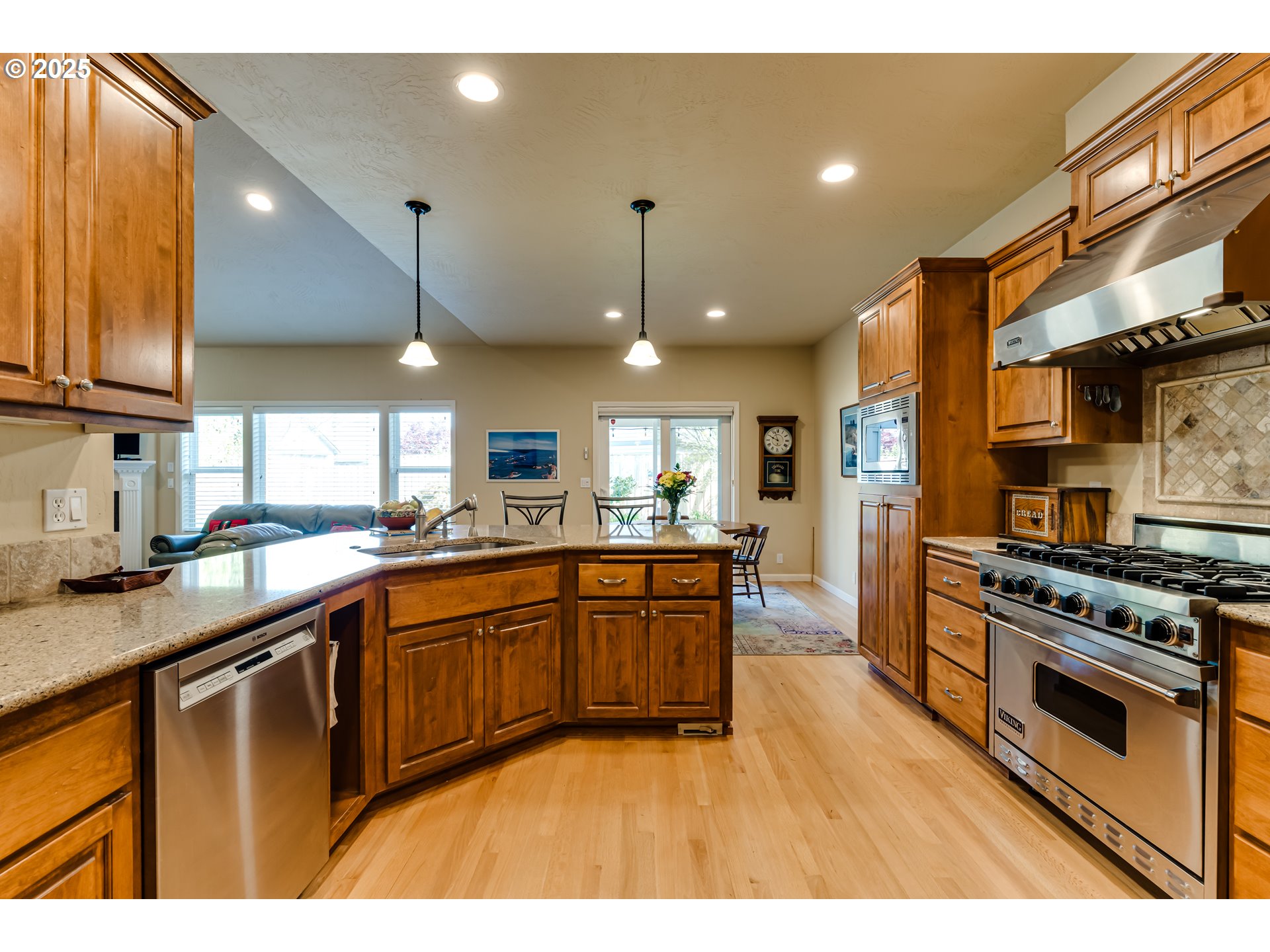 3351 Cape Hatteras Drive Eugene, OR 97408 - Photo 16 of 47 a kitchen with stainless steel appliances granite countertop a sink a stove and a wooden floors