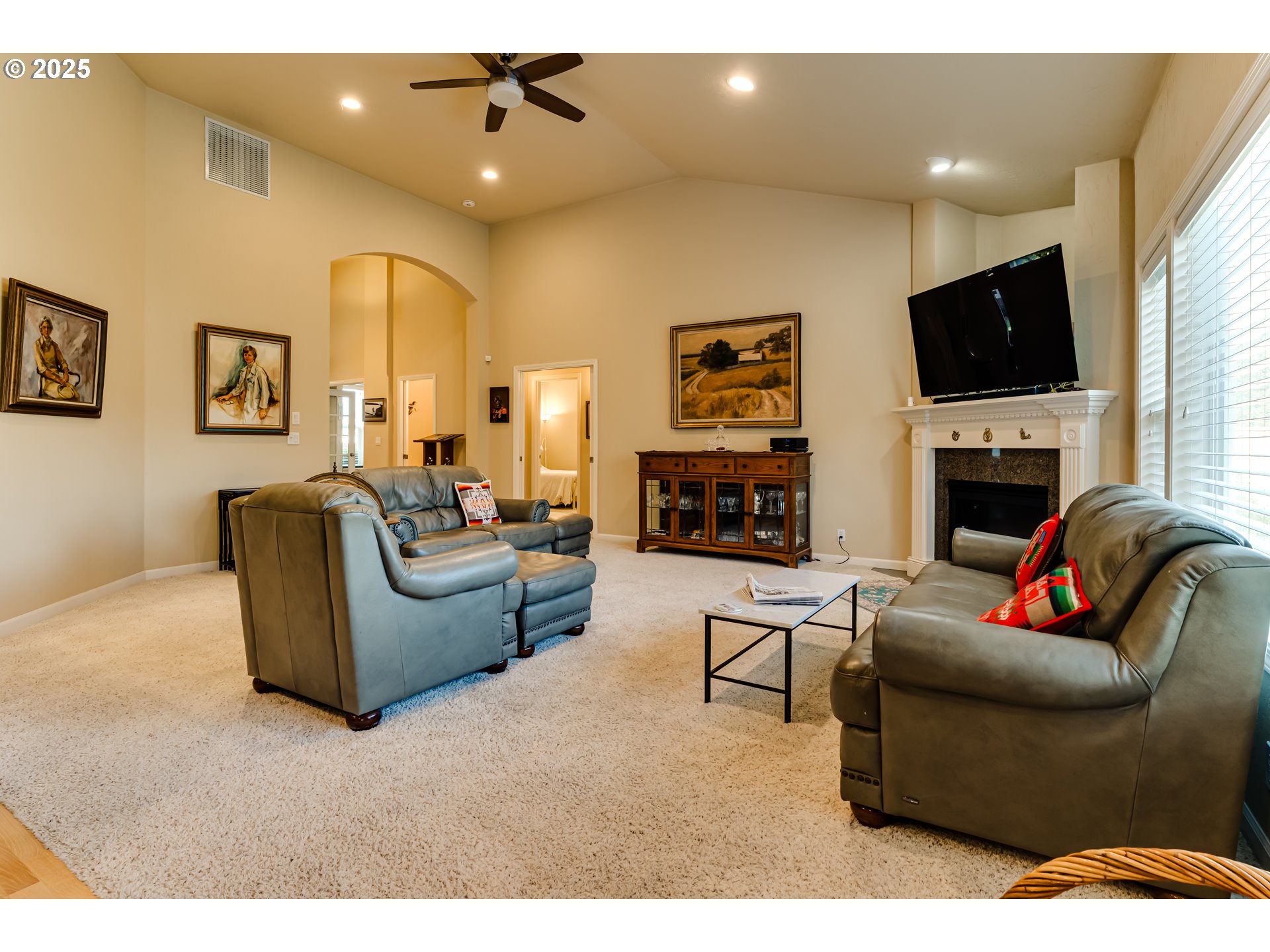 3351 Cape Hatteras Drive Eugene, OR 97408 - Photo 23 of 47 a living room with furniture a flat screen tv and a fireplace