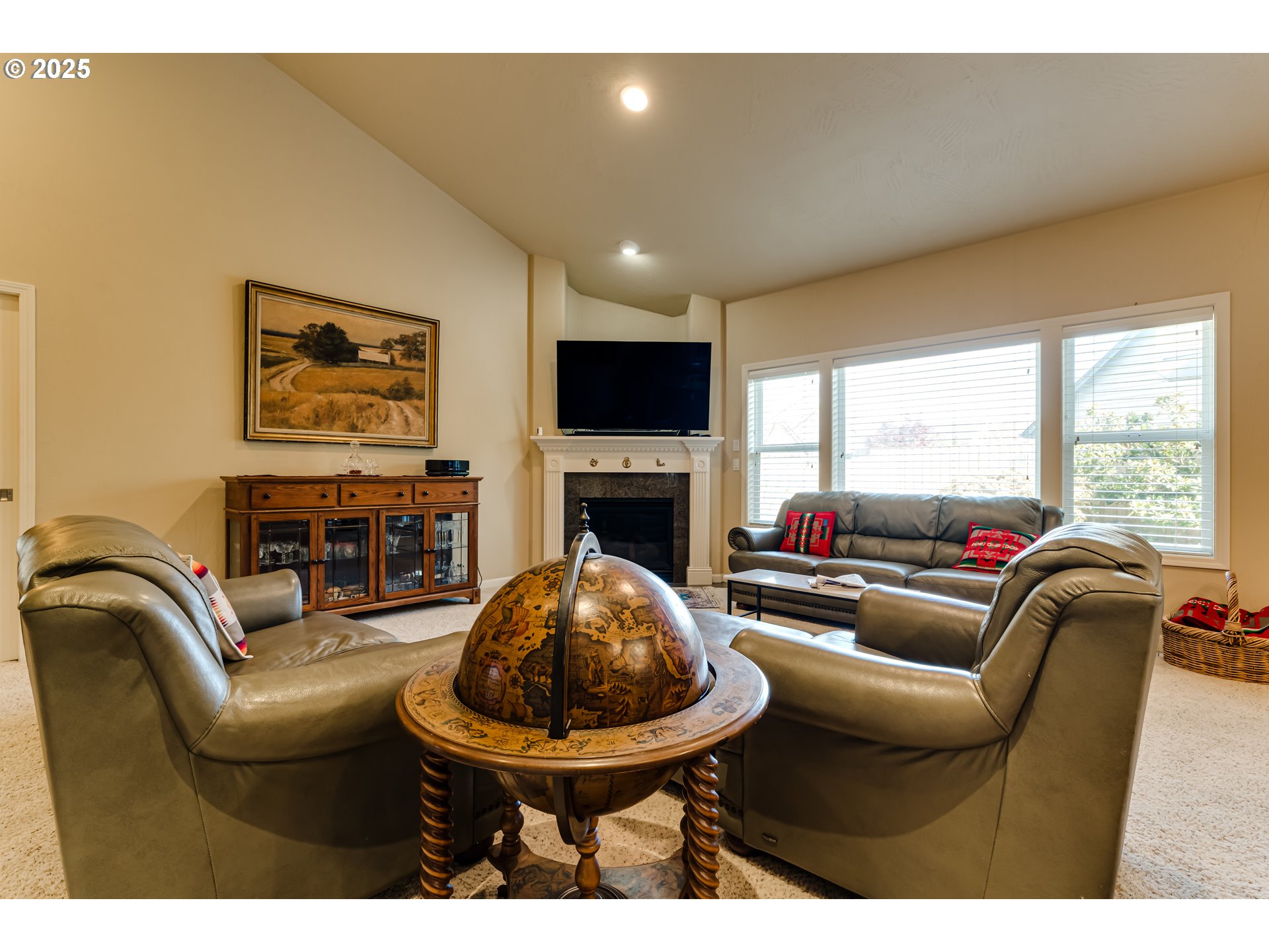3351 Cape Hatteras Drive Eugene, OR 97408 - Photo 24 of 47 a living room with furniture a fireplace and a flat screen tv
