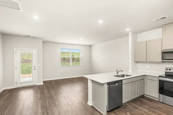 a kitchen with a sink stove and cabinets