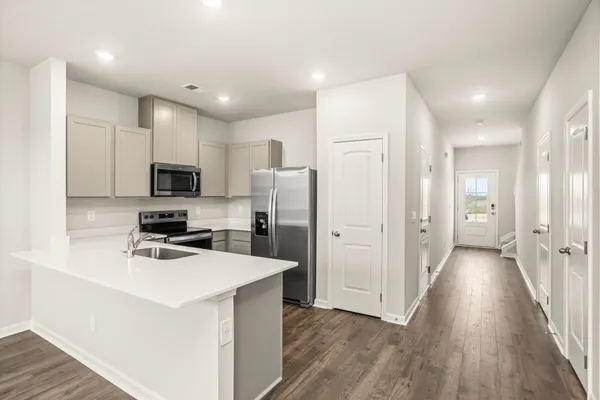 a kitchen with stainless steel appliances a refrigerator sink and microwave