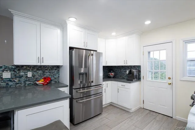a kitchen with stainless steel appliances a refrigerator a sink a stove a microwave and cabinets