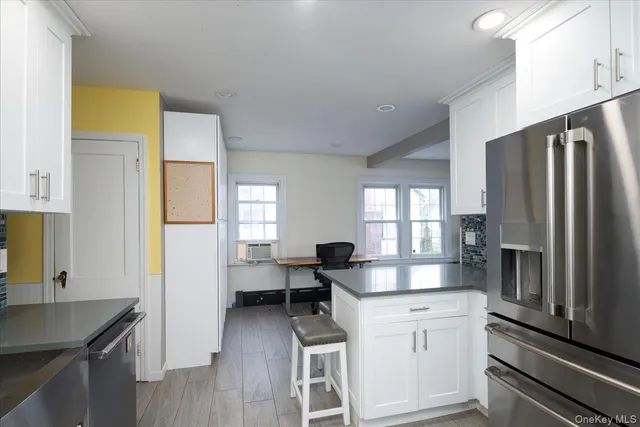 a kitchen with stainless steel appliances a refrigerator sink and cabinets