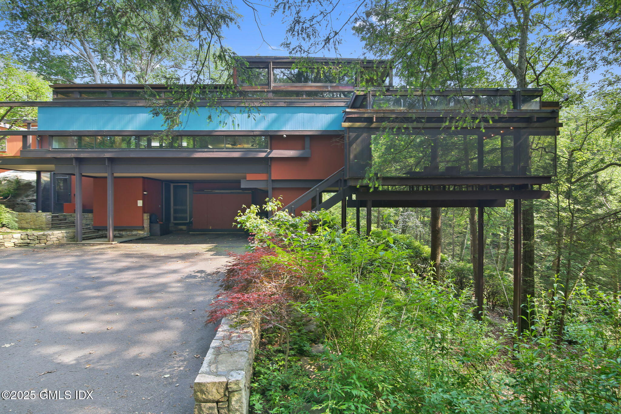 a view of a brick house with a yard and plants
