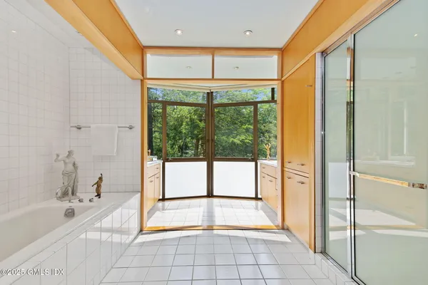 a spacious bathroom with a large tub and shower