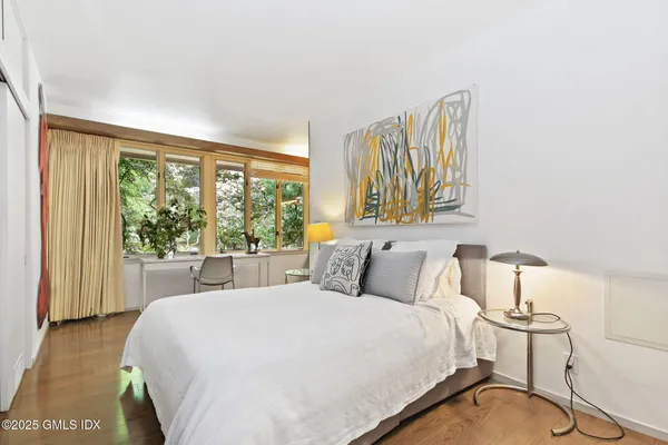 a bedroom with a bed and with a window