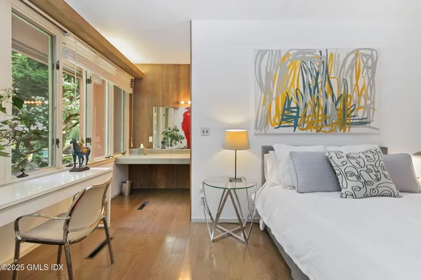 a bedroom with a bed and a table