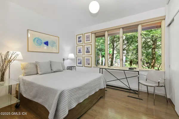 a spacious bedroom with a bed and a window