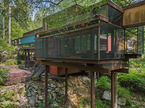a view of a chair and table in backyard